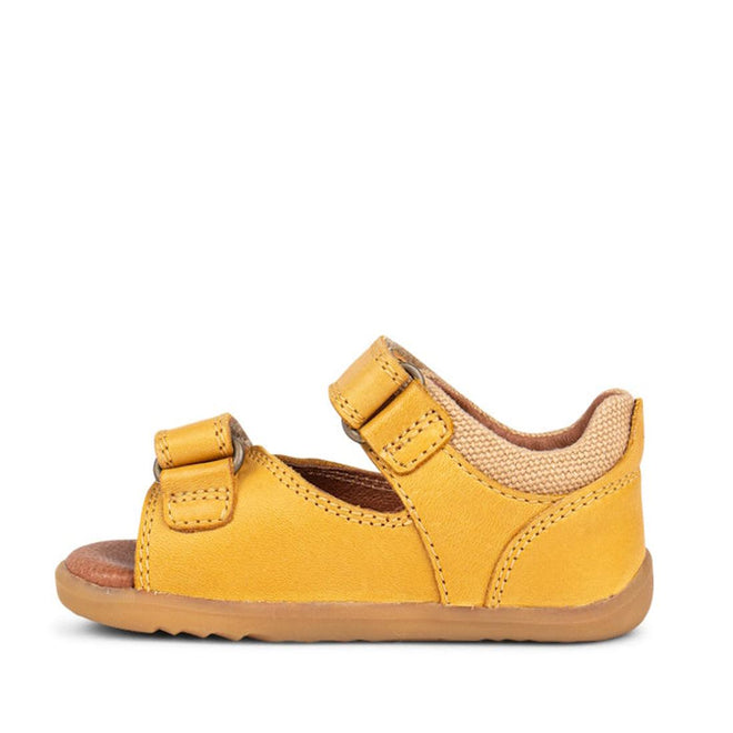 The Bobux Step Up SU Driftwood Toddlers Sandal in Chartreuse Yellow (728608) features premium leather, two adjustable Velcro straps, a brown rubber sole, and an open toe—ideal for first walkers. Shown in side profile on a white background., 9420062001387, 9420057330690, 9420057330706
