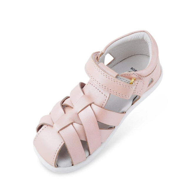 The Bobux Iwalk IW Tropicana II Sandal 638305 in Seashell Pink is a kids' sandal with closed toe, quick-dry leather woven straps, hook-and-loop ankle closure, and a white sole—ideal stylish summer footwear against a white background., 9420068504356, 9420068504363, 9420068504370, 9420068504387, 9420068504394