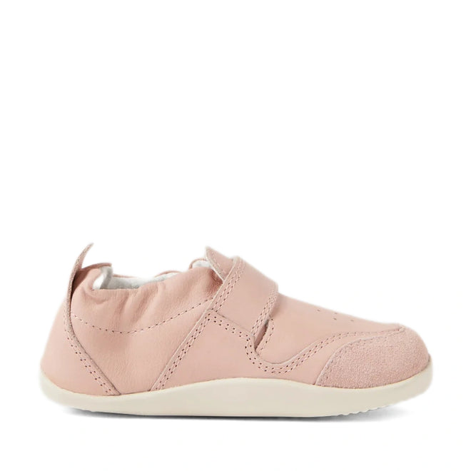 The Bobux XP Explorer Ripple First Walker Cameo Rose 502603 is a single soft pink baby shoe with a flexible white sole, velcro strap, and suede toe cap, photographed from the side on a white background—perfect as stylish first walker shoes for your little one., 42846, 9420068568518, 9420068568525, 9420068568532