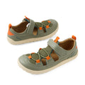 Two Vetiver Green Bobux Kid+ KP Rocky closed-toe leather barefoot sandals for kids, featuring beige soles, orange and olive mesh and leather details, adjustable straps, and orange pull tabs at the back. Designed to support natural foot movement, both sandals are displayed facing outward on a white background.