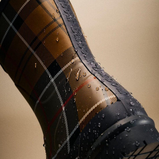 Close-up of Barbour Banbury Tartan Mid Calf Wellys Womens Rainboot featuring a brown, black, and white tartan pattern with water droplets on the surface, set against a neutral background., 5063669171042, 5063669171059, 5063669171066, 5063669171073, 5063669171080, 51377