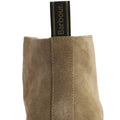 Close-up of the back of a Barbour Mens Blaine Chukka Lace Up Taupe Suede Boot, showing its suede finish and a black and gold pull tab with "Barbour" in gold lettering., 5063669166789, 5063669166796, 5063669166734, 5063669166741