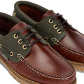 A close-up of Barbour Mens Re-Engineered Deck Boat Shoes Mahogany shows brown leather, green canvas, tan stitching, gold eyelets, black laces, Barbour logo tag on the side, and textured brown soles—versatile men’s casual footwear., 5020985780440, 5020985781133, 5020985777563, 51884