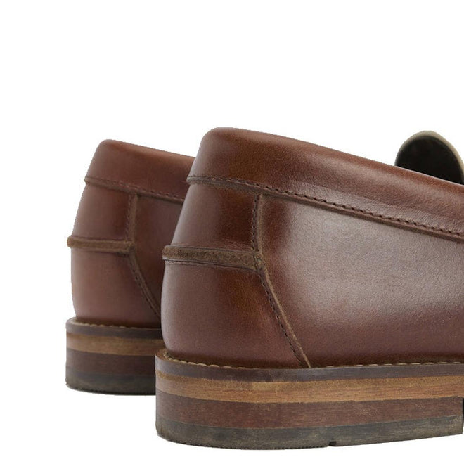 Close-up of the Barbour Jen Mahogany & Beige Women's Tassel Leather Loafer heels, highlighting stitching, smooth leather finish, and stacked wooden detail against a white background., 5063669169094, 5063669169100, 5063669169117, 5063669169124, 5063669169131, 51844