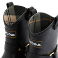 A close-up of two Barbour Elley Harness Black Wellington Womens Rainboots with tartan linings, front Barbour logos, pull loops, and metal side buckles, highlighting their classic harness style., 5020985983018, 5020985983575, 5020985984107, 5020985984558, 5020985984947, 5020985985340
