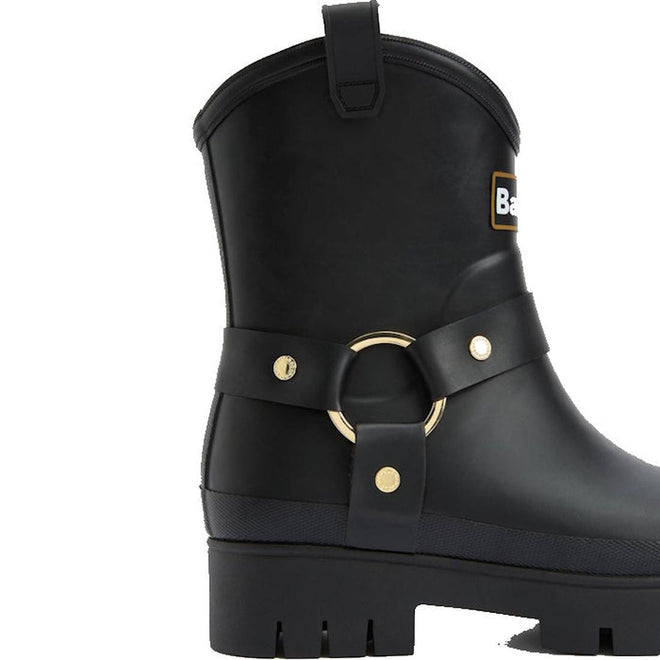 The Barbour Elley Harness Black Wellington Women's Rainboot is a black rubber ankle boot with a thick treaded sole, decorative strap, gold ring and studs—stylish, rain-ready footwear inspired by classic harness Wellington boots., 5020985983018, 5020985983575, 5020985984107, 5020985984558, 5020985984947, 5020985985340