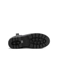The image displays the black rubber sole of a Barbour Elley Harness Black Wellington Womens Rainboot on its side, featuring a chunky tread pattern with rectangular and cross-shaped grips against a plain white background., 5020985983018, 5020985983575, 5020985984107, 5020985984558, 5020985984947, 5020985985340