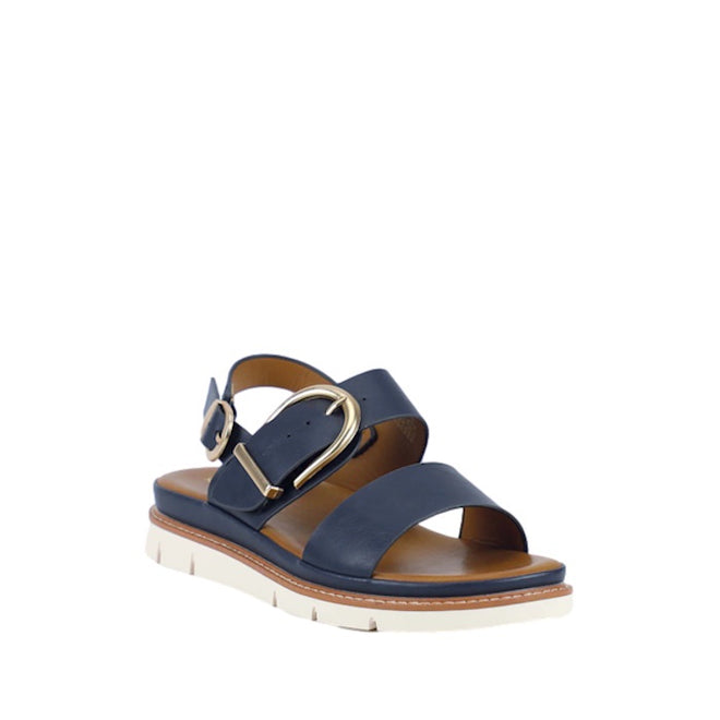 The Soultbush Garie Navy Blue Women’s Sandal with Back Strap features two wide straps, a gold buckle, a cushioned footbed, and a white sole with stitching detail, displayed against a white background.