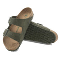 A pair of desert dust thyme Green  arizona vegan slide sandals with cork sole on a white background. showing the front, sole and inner foot view of the left foot leaning against the right foot showing the eva balck sole