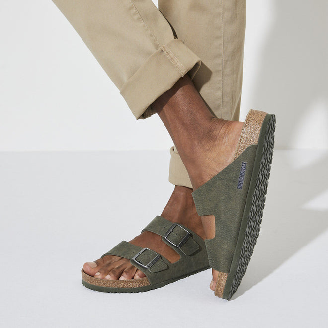 Person wearing birkenstock vegan green sandals 2 strap slides with a white background.,4061418353306,
4061418353344,
4061418353382,
4061418353429,