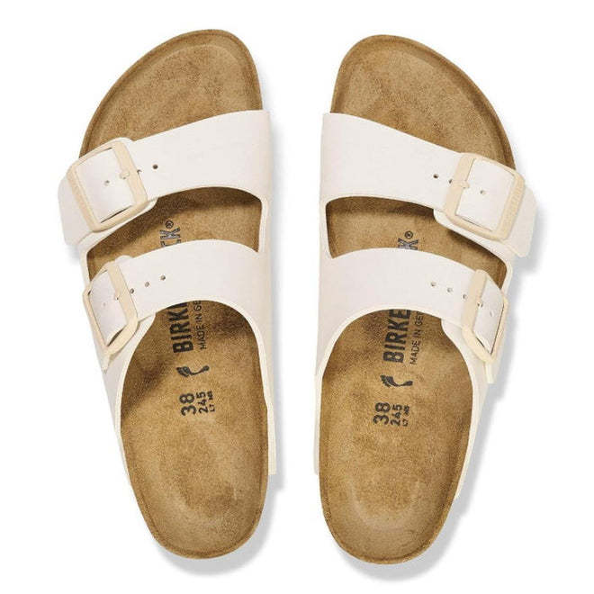 Top down view of Arizona Eggshell White Birkenstock Birko Flor sandals with beige soles on a white background. Showing buckle adjustable double straps.,
4066648369509,
4066648369547,
4066648369585,