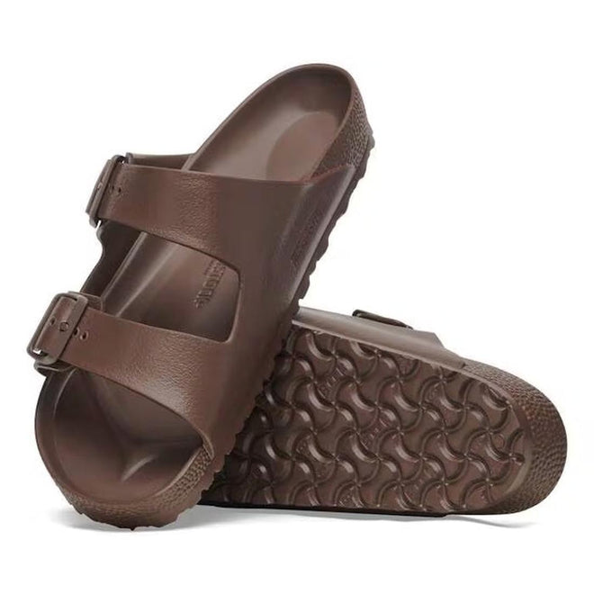 A pair of BIRKENSTOCK Arizona EVA Brown Roast REGULAR Width sandals with two adjustable straps and textured, waterproof soles. One sandal stands upright; the other lies on its side, displaying the tread pattern.
