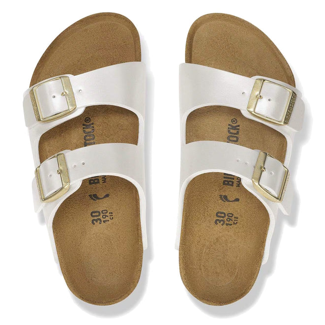 A pair of Birkenstock Kids Arizona Metallic Pearl White Narrow Slides with two adjustable straps, silver buckles, and a cork footbed, displayed from above on a plain white background., 48068, 48069, 48070, 48071, 48072, 48073, 48074, 48075, 48076