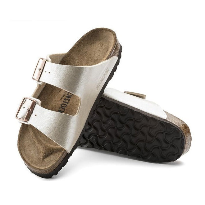 A pair of Birkenstock Arizona Birko Flor sandals in pearl white color with adjustable buckles and a contoured cork-latex footbed. showing the top down and inner foot side view of the right foot and the sole of teh elft foot.