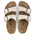 top down view showing the insole of both feet of an Arizona 2 strap sandal in graceful pearl white showing the goldl burnished looking birkenstock buckles adjustable on the 2 straps of both feet.,4044477107172,4044477107196,4044477107219,4044477107233,4044477107257,4044477107271,,,,,,,

