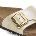 Close-up of the Birkenstock Womens Catalina Cushion Buckle sandal in Pearl White Birko-Flor, featuring a cork-latex contoured footbed, large shiny gold buckle on the strap, and a dark outsole. Regular width., 4066648995265, 4066648995302, 4066648995340, 4066648995388, 4066648995425, 4066648995463, 47502