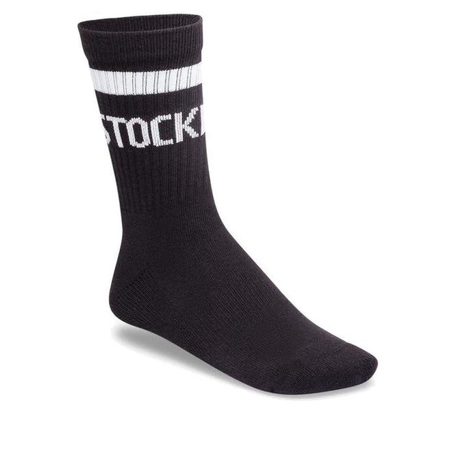 The BIRKENSTOCK Crew Tennis Striped Socks Black feature two white stripes and partial 'STOCK' text on the cuff, shown on a white background, and provide an ultra-soft comfort sole.