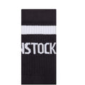 A close-up of black BIRKENSTOCK Crew Tennis Striped Socks made from organic cotton, featuring a white stripe, comfort sole, and partial "STOCK" text., 4067707315529, 50390, 4067707315543