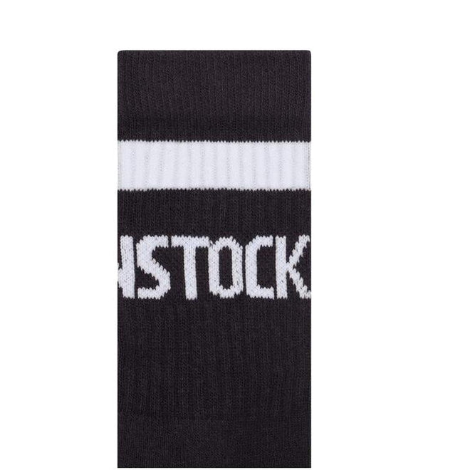 A close-up of black BIRKENSTOCK Crew Tennis Striped Socks made from organic cotton, featuring a white stripe, comfort sole, and partial "STOCK" text., 4067707315529, 50390, 4067707315543