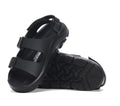 The Birkenstock Mogami Terra Kids Black Birko Flor Sandal features adjustable straps and rugged, textured soles—perfect water-friendly sandals for active kids. One stands upright, the other lies on its side to showcase durability.