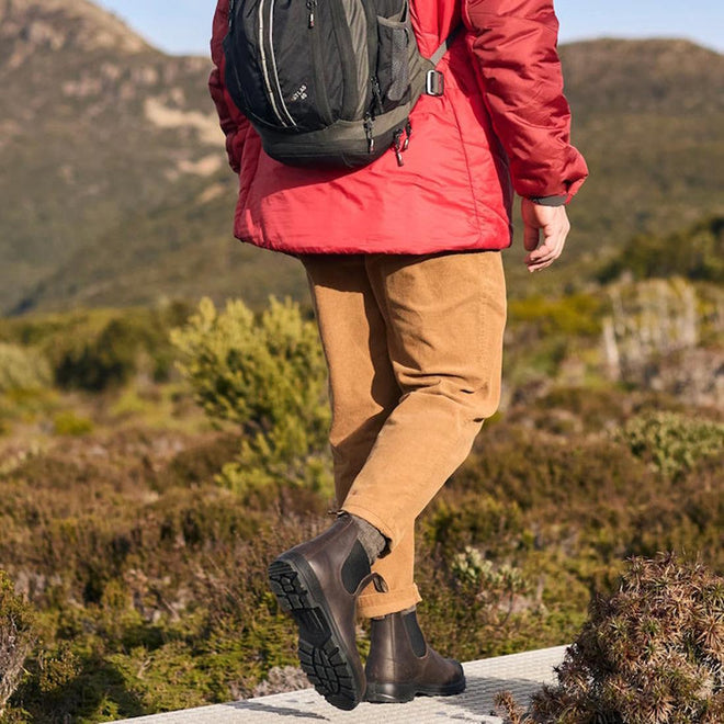 a picture showing a man on a hike walking away from the camera wearing 2340 bludstone boots. Lifting the right foot that shows the sole and the left foot on the ground showing the inner of the boot., 
9315891562553,
9315891562577,
9315891562591,
9315891562614,
9315891562638,
9315891555692,
9315891562669,
9315891562683,
9315891562690