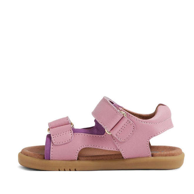 The Bobux IW Iwalk Strand Sandal Lilas Pink Open Toe features pink and purple hues, adjustable hook-and-loop straps, and a tan rubber sole, shown in side profile against a white background., 9420068556942, 9420068556959, 9420068556966, 9420068556973, 9420068556980