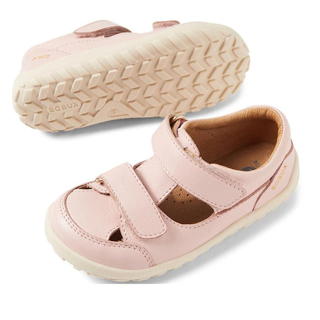 A pair of Bobux IW Iwalk Troop Toddlers Leather Sandal in Cameo Rose Pink, with Velcro straps and beige textured rubber soles, is displayed—one upright and the other showing the sole.