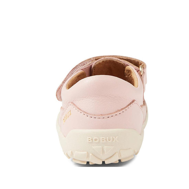 A rear view of a pink Bobux IW Iwalk Troop Toddlers Leather Sandal in Cameo Rose features a white zero drop sole, BOBUX embossed on the heel, a visible Velcro strap on top, and tan interior lining., 46383, 9420068562561, 9420068562578, 9420068562585, 9420068562592
