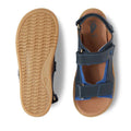 The Bobux Kid+ Plus Strand Navy Open Toe Sandal is shown from the top and bottom, highlighting its navy color, tan textured soles, breathable design, and adjustable velcro straps for kids., 9420068557048, 9420068557055, 9420068557062, 9420068557079, 9420068557086, 9420068557093, 9420068557109