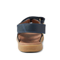 A close-up rear view of the Bobux Kid+ Plus Strand Navy Open Toe Sandal, featuring a navy blue design, brown cushioned sole with BOBUX embossed on the heel, and adjustable Velcro straps for a secure, customizable fit., 9420068557048, 9420068557055, 9420068557062, 9420068557079, 9420068557086, 9420068557093, 9420068557109