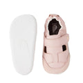 The Bobux XP Explorer Beau First Walker Sandal in Ballet Pink features premium leather, a closed toe, a front strap, white soles, and an elasticized ankle. One shoe is shown from the top and the other from the bottom., 48687, 9420068568969, 9420068568976, 48690