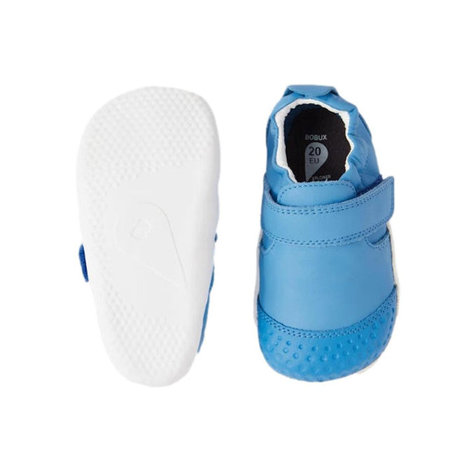 The Bobux Explorer Go First Walking Trainer in Azure Blue features a soft leather upper, hook-and-loop strap, and flexible white sole; one shoe is shown from the top and the other highlights the textured bottom., 48682, 9420068567900, 9420068567917, 9420068567924, 9420068567931