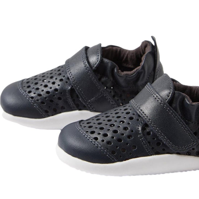 The Bobux Xplorer Go Punch Navy First Walker Sandal features perforated uppers, velcro straps, and white rubber soles. Lightweight and flexible, these sandals are ideal for babies taking their first steps. Displayed on a white background., 9420075786547, 9420075785717, 9420075785809, 9420075785748