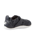 The Bobux Xplorer Go Punch Navy First Walker Sandal is a navy blue pre-walker with perforated holes, white sole, Velcro strap, and a white heel logo. This lightweight, flexible baby shoe is shown from the back side angle., 9420075786547, 9420075785717, 9420075785809, 9420075785748