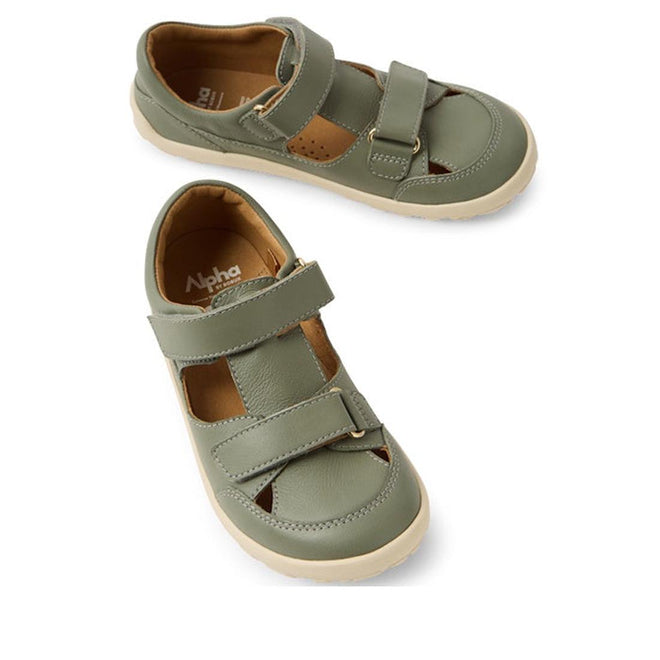 Bobux Kid+ Troop Leather Closed Toe Sandal in Vetiver Green: children's shoes with a wide toe box, beige rubber sole, flexible sole, Velcro straps, and closed toe design, shown on a white background.