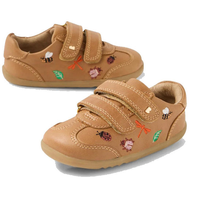 Bobux Step Up Buggie Embroidered First Walker Sneaker in Caramel features double velcro straps, soft soles, and Quickdry leather. Adorned with bees, ladybugs, leaves, and red bows—ideal for first walkers seeking comfort and style.