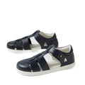 A pair of Bobux Kid + Plus Tidal Closed Toe Quick Dry Sandals in navy (style 834404A), featuring closed toes, white soles, and velcro straps, crafted from quick dry leather, displayed on a white background.