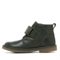The Clarks Charlie Dark Olive Toddlers Leather Boot features dark green leather, a wide self-fastening strap, visible stitching, pull tab at the back, and a flat tan rubber sole. Shown in side profile on a white background., 9336078963895, 9336078963901, 9336078963918, 9336078963925, 9336078963932