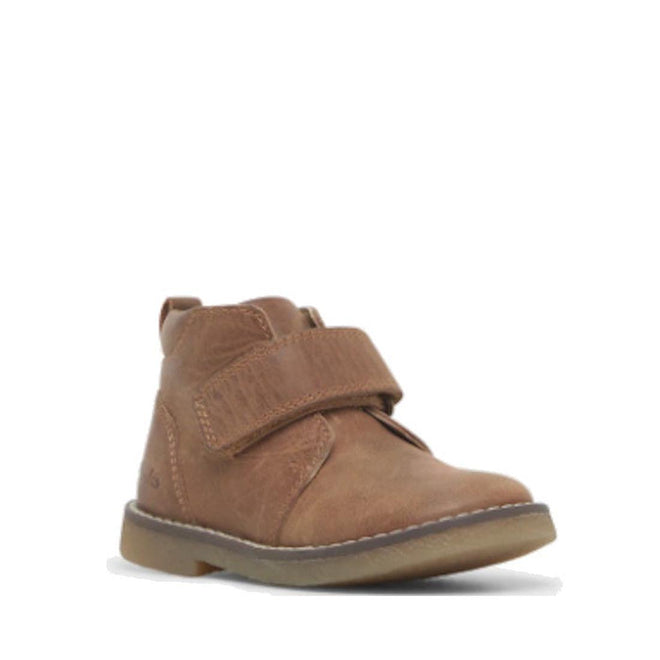 The Clarks Charlie Tan Toddlers Leather Boot features a single brown leather design with a rounded toe, self-fastening strap, visible stitching, and a light brown rubber sole. The style is similar to a classic Chelsea boot on a plain white background.
