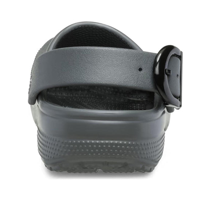 A close-up rear view of the Crocs Adults Classic Enamel Buckle Clog in Carbon Grey, featuring an adjustable backstrap with a black buckle and showcasing its textured sole and heel area., 51696, 198445415715, 198445415722, 198445415739, 51700, 51701, 51696, 198445415715, 198445415722, 198445415739, 198445415746, 51701