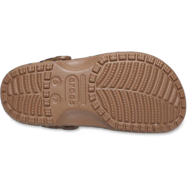 Bottom view of the Crocs Adults Classic Animal Clog in Sepia Leopard Print, displaying the tread pattern, size markings “6 7” and “5 7,” and the Crocs brand name molded into the sole; this style can be personalized with Jibbitz charms for a unique touch., 53072, 198445262883, 198445262890, 198445262906, 198445262913, 53077, 53078
