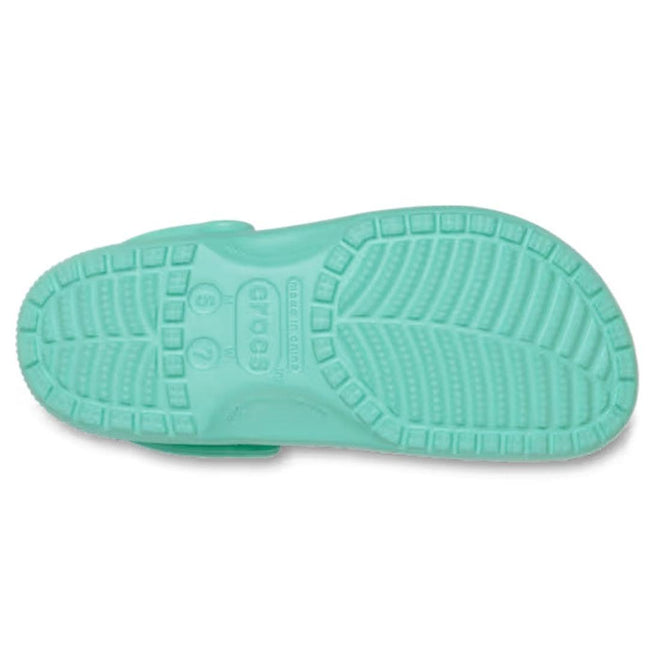 The Crocs - Classic Clog Adults Retro Green is shown from the bottom, revealing its textured sole with tread patterns and central Crocs logo—highlighting these lightweight, comfortable unisex shoes., 51783, 198445410260, 198445410277, 198445410284, 198445410291, 51788, 51789, 51790, 51791