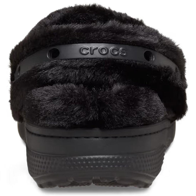 A close-up front view of the Crocs Adults Unfurgettable Lined Clog Black Fluffy, showcasing its plush fuzzy lining for cozy comfort and a black strap embossed with the Crocs logo., 198445190681, 198445190698, 198445190704, 198445190711, 198445190728, 198445190735, 198445190643, 198445190650, 198445190667, 198445190674