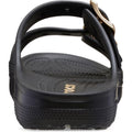 Rear view of a black Crocs Womens Classic Metallic Buckle Saturday Sandal Slide, featuring a textured sole, adjustable top straps, and a gold buckle on the right. "CROCS" is partially visible on the footbed for signature comfort., 50021, 198445392788, 198445392795, 198445392801, 198445392818, 198445392740, 198445392757