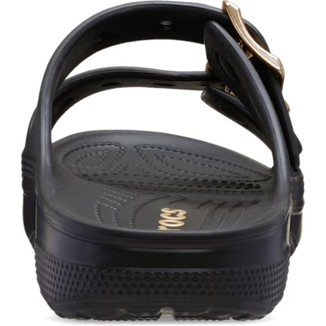 Rear view of a black Crocs Womens Classic Metallic Buckle Saturday Sandal Slide, featuring a textured sole, adjustable top straps, and a gold buckle on the right. "CROCS" is partially visible on the footbed for signature comfort., 50021, 198445392788, 198445392795, 198445392801, 198445392818, 198445392740, 198445392757