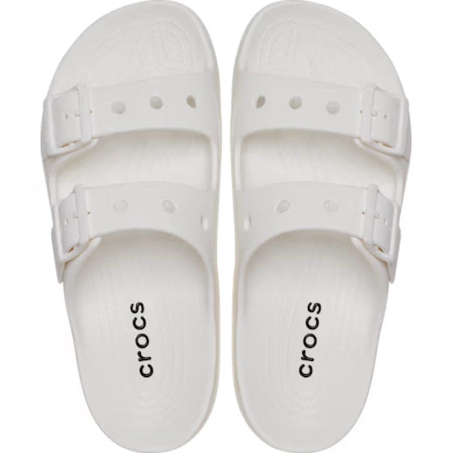 A pair of Crocs Womens Classic Saturday Sandal Slide White, featuring Crocs Comfort, two adjustable straps with buckles, and “crocs” printed in black on the footbeds, shown from above., 50014, 50015, 198445397431, 198445397448, 198445397455, 50019, 50020