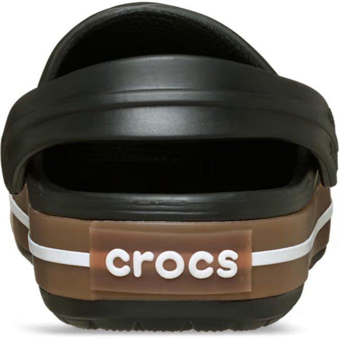 Rear view of the Crocs Kids Crocband Gum Clog Black, featuring a brown heel band with a white stripe and a centered Crocs Comfort logo patch.