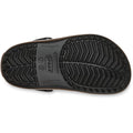 Bottom view of a black Crocs Kids Crocband Gum Clog showing the textured, chevron-patterned tread and the brand logo molded into the sole.
