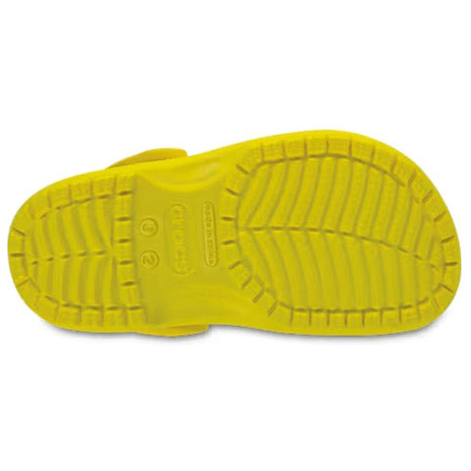 The bright yellow outsole of a Crocs Kids Classic Clog K Lemon Yellow Youth/Juniors, featuring a textured tread pattern and center branding., 191448736269, 191448736276, 191448736283, 191448736290, 191448736306, 191448736313, 54699, 54700, 54701
