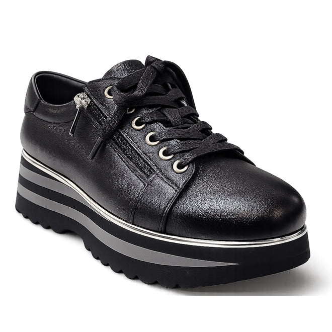 The Django & Juliette Eammes Black Leather Platform Shoe for women features black laces, a side zipper, silver eyelets, and a thick black and silver striped sole with wavy tread—perfect for women's leather platform shoe enthusiasts.